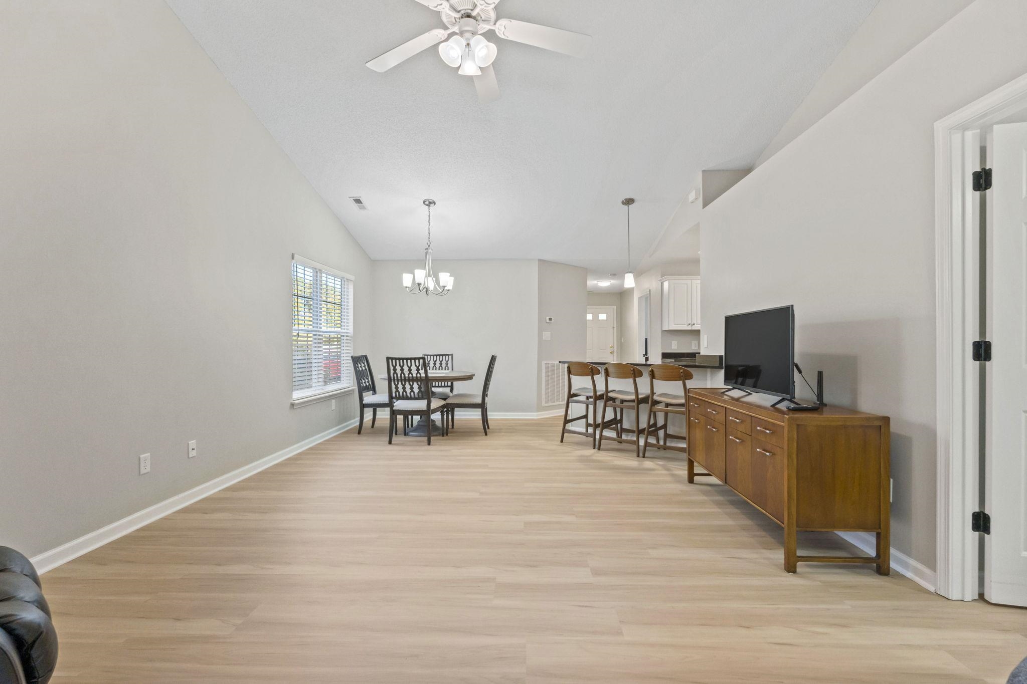 135 Country Manor Drive, Unit B Conway, SC 29526 - Photo 12 of 40 Living area featuring light wood finished floors, vaulted ceiling, ceiling fan, and a chandelier