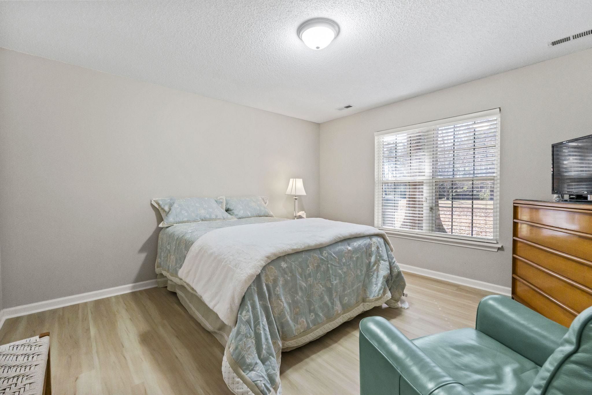 135 Country Manor Drive, Unit B Conway, SC 29526 - Photo 15 of 40 Bedroom with a textured ceiling and light wood-type flooring