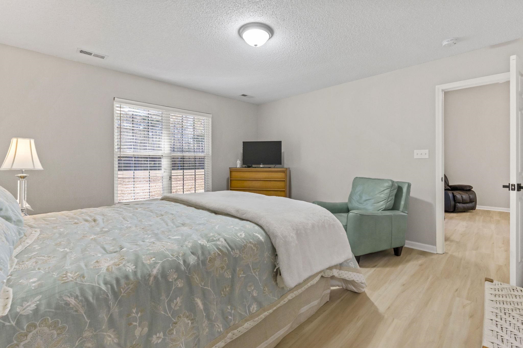 135 Country Manor Drive, Unit B Conway, SC 29526 - Photo 17 of 40 Bedroom with a textured ceiling and wood finished floors