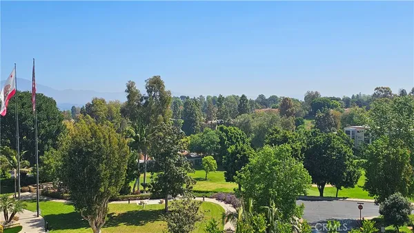 an aerial view of a house with a yard and lake view