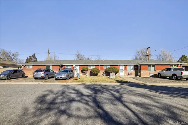 a view of a cars park in front of a building