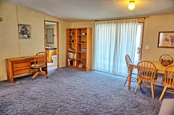 a view of a livingroom with furniture and a window