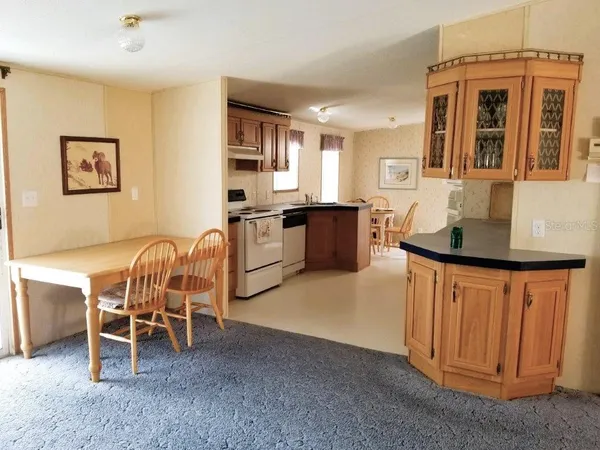 a kitchen with granite countertop a sink stove and cabinets