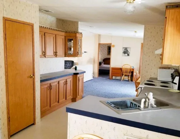 a kitchen with stainless steel appliances granite countertop a sink and cabinets