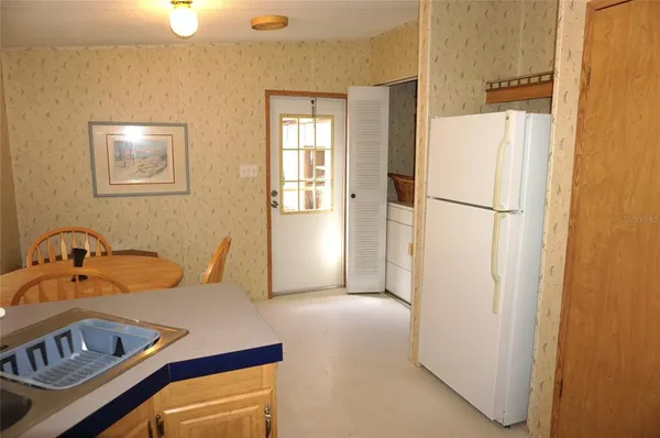 a bedroom with a bed and a refrigerator