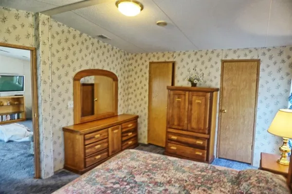 a view of room with furniture and wooden floor