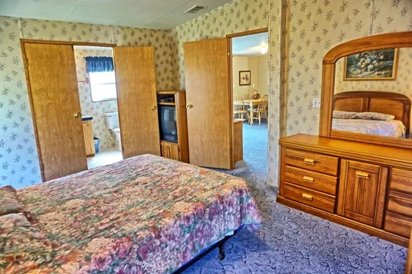 a bedroom with a bed and a dresser in it