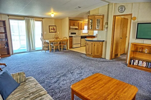 a view of kitchen with furniture and windows