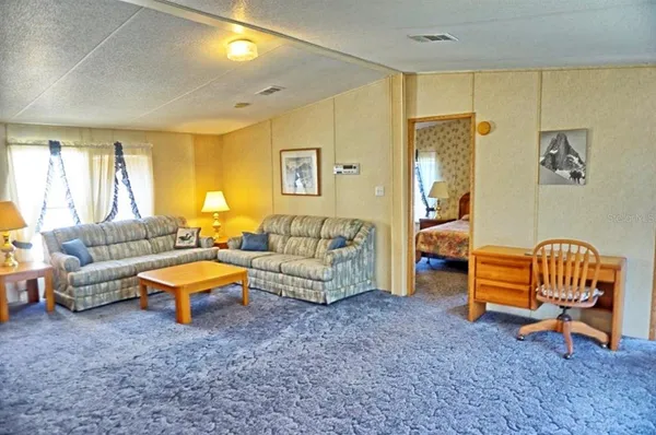 a living room with furniture and a rug