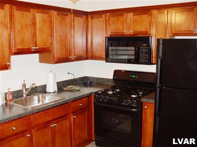 706 East 5th Street Bethlehem, PA 18015 - Photo 2 of 9 a kitchen with granite countertop a refrigerator stove and sink