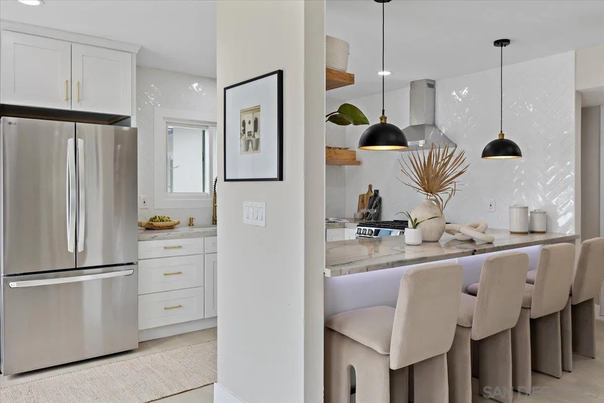3663 Oleander Drive San Diego, CA 92106 - Photo 11 of 46 a kitchen with kitchen island a counter top space appliances and cabinets