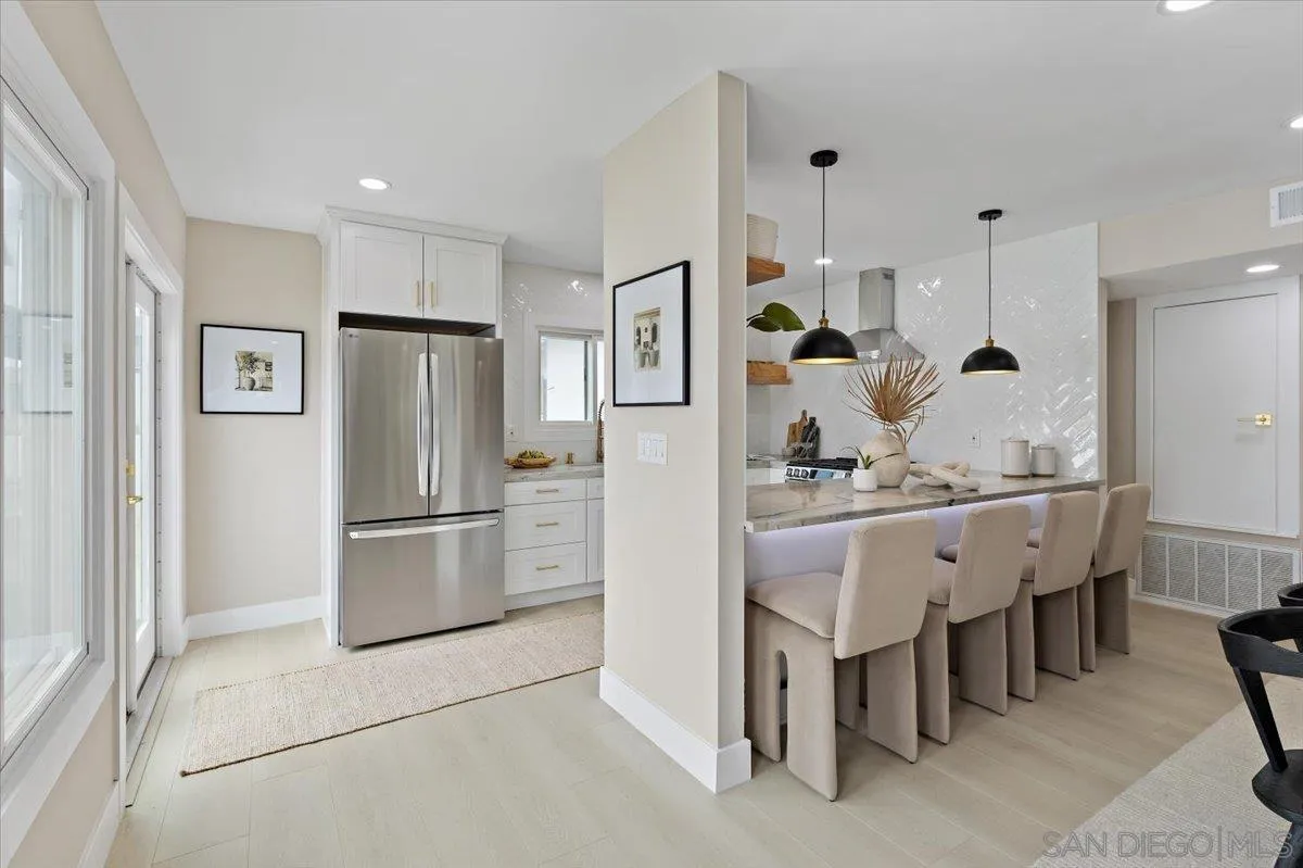 3663 Oleander Drive San Diego, CA 92106 - Photo 10 of 46 a kitchen with refrigerator and chairs