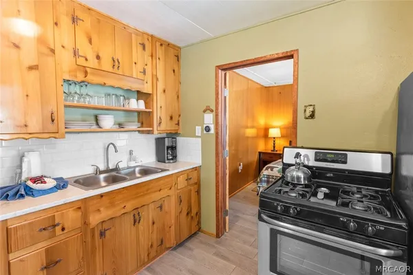 a bedroom with a bed and a dresser next to a window