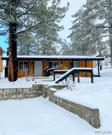 a dining room with a fireplace and wooden floor