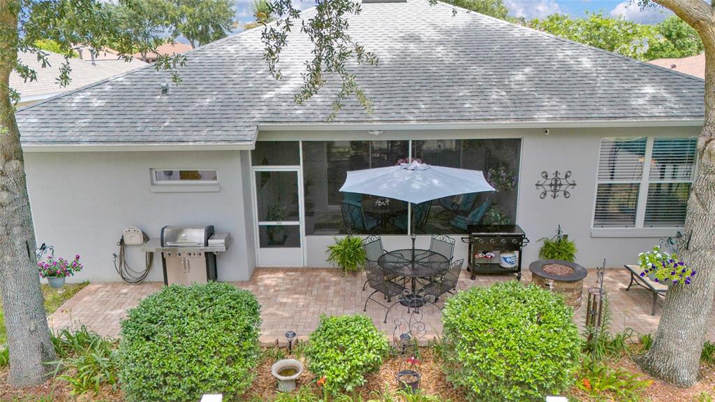16411 Southwest 14th Avenue Road Ocala, FL 34473 - Photo 36 of 59 an outdoor view of patio with a table and chairs under an umbrella