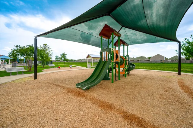 a view of a swimming pool with a yard