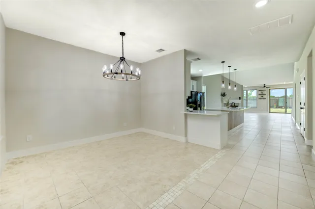 a view of a kitchen with a sink and chandelier