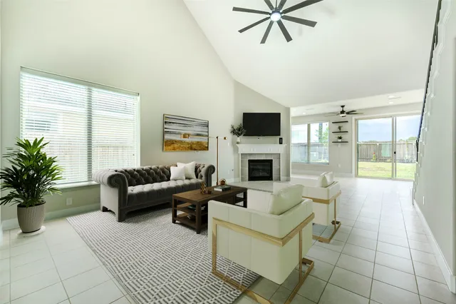 a living room with furniture a fireplace and a flat screen tv