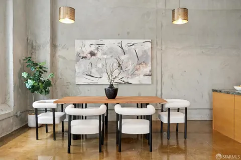 a dining room with furniture and wooden floor