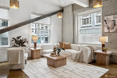 a living room with furniture and floor to ceiling windows
