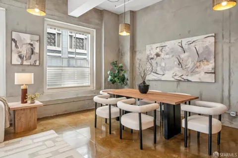 a dining room with furniture and window