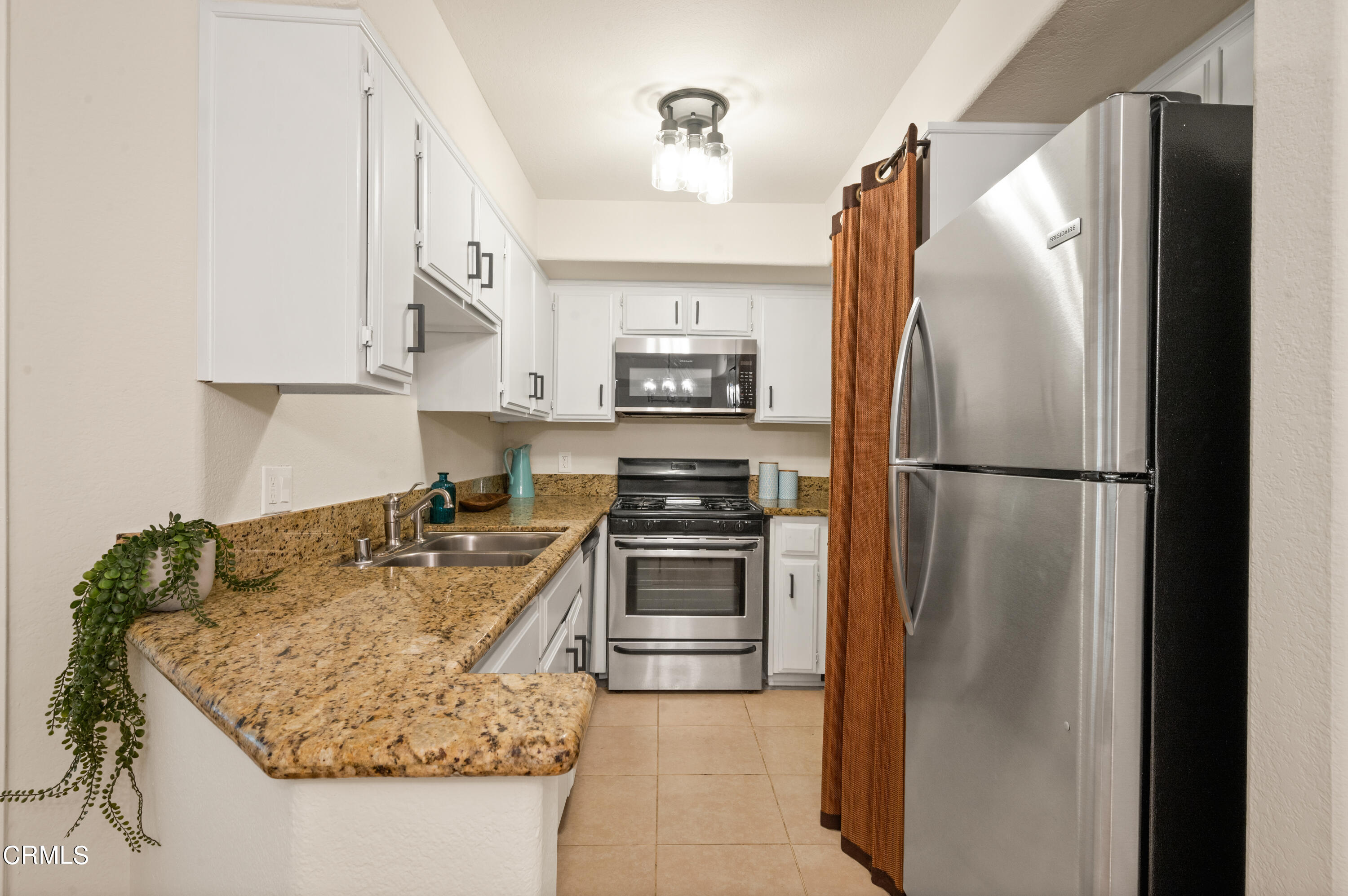 6140 Monterey Road, Unit 220 Los Angeles, CA 90042 - Photo 12 of 43 a kitchen with granite countertop a refrigerator and a stove