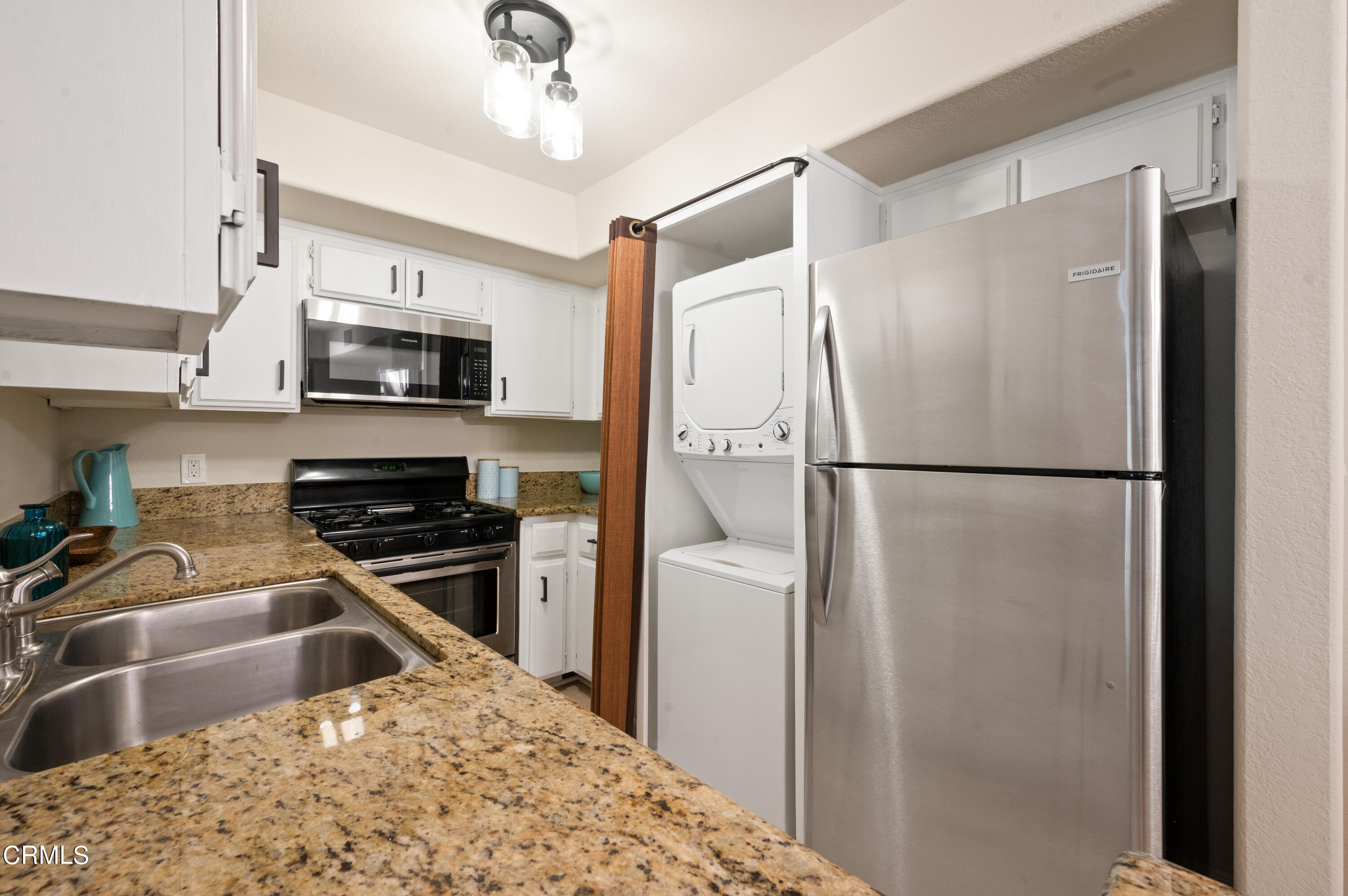 6140 Monterey Road, Unit 220 Los Angeles, CA 90042 - Photo 15 of 43 a kitchen with stainless steel appliances granite countertop a refrigerator a sink a stove a microwave and wooden cabinets