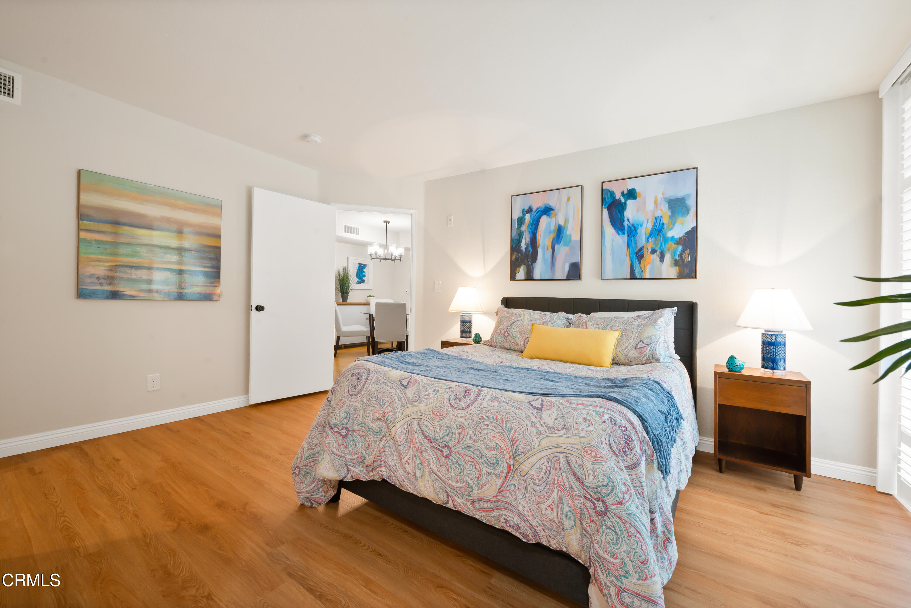 6140 Monterey Road, Unit 220 Los Angeles, CA 90042 - Photo 19 of 43 a spacious bedroom with a bed and painting on the wall