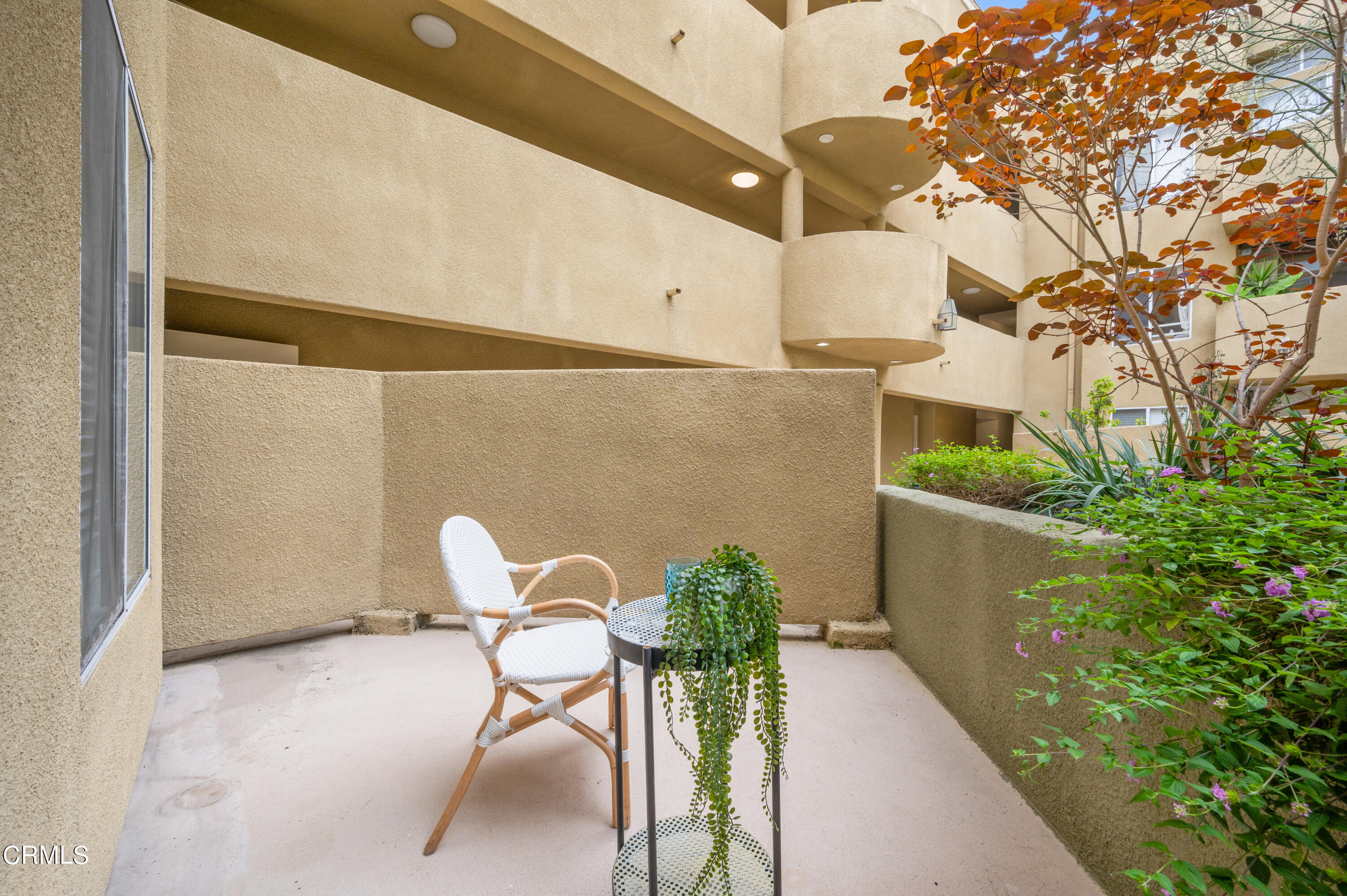 6140 Monterey Road, Unit 220 Los Angeles, CA 90042 - Photo 28 of 43 a patio with table and chairs and potted plants