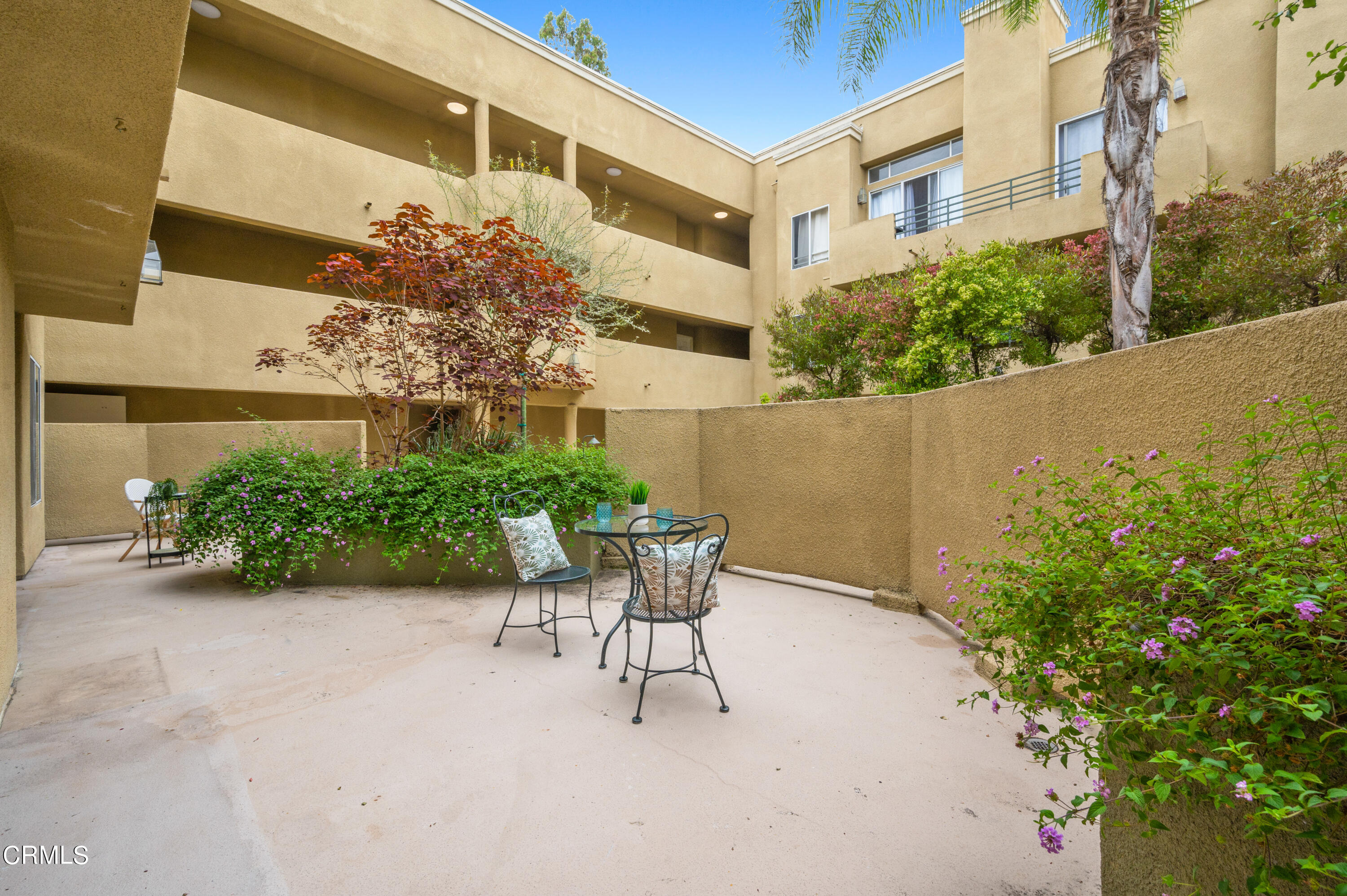 6140 Monterey Road, Unit 220 Los Angeles, CA 90042 - Photo 32 of 43 a view of a patio with plants and table and chairs and potted plants
