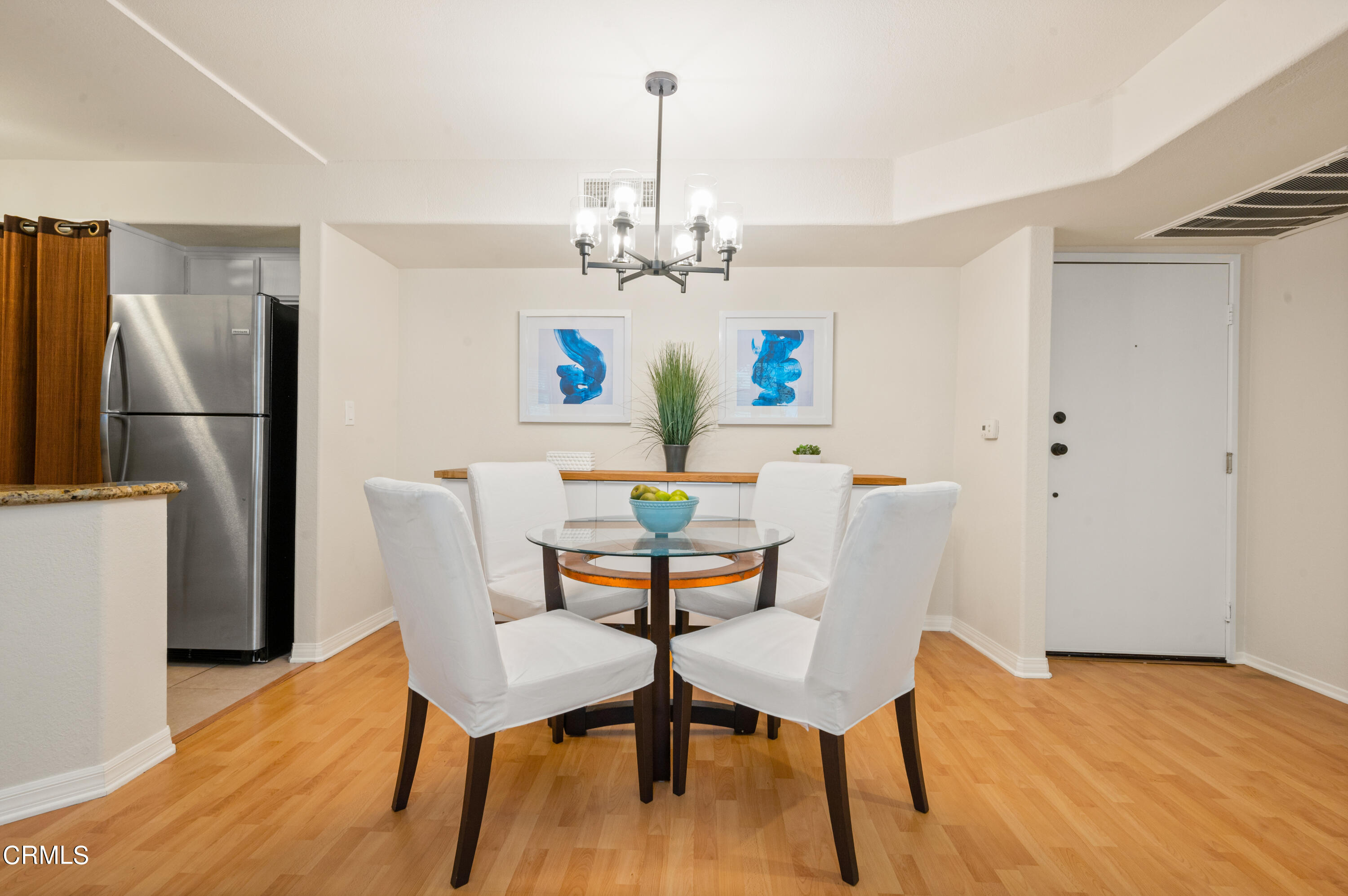 6140 Monterey Road, Unit 220 Los Angeles, CA 90042 - Photo 10 of 43 a dining room with furniture a chandelier and wooden floor