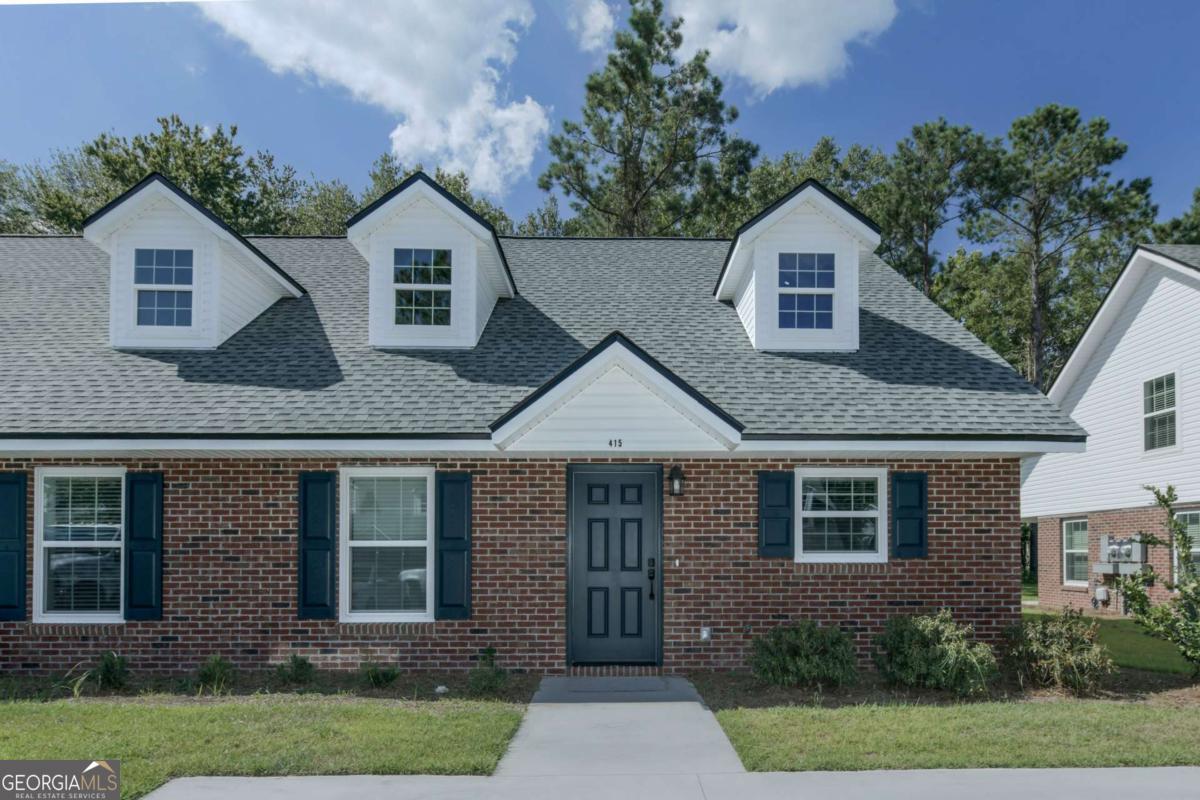 411 Madison Avenue St. Marys, GA 31558 - Photo 1 of 41 a front view of a house with garden
