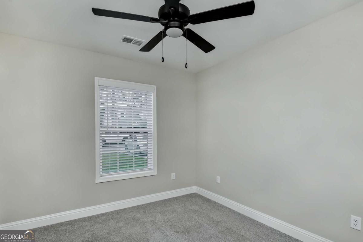 411 Madison Avenue St. Marys, GA 31558 - Photo 13 of 41 an empty room with a window and a fan