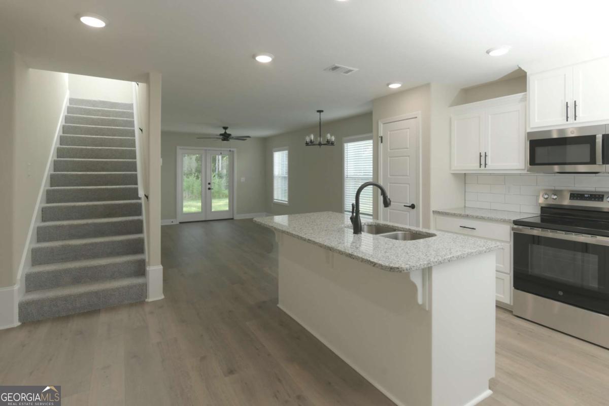 411 Madison Avenue St. Marys, GA 31558 - Photo 4 of 41 a kitchen with stainless steel appliances a sink and cabinets
