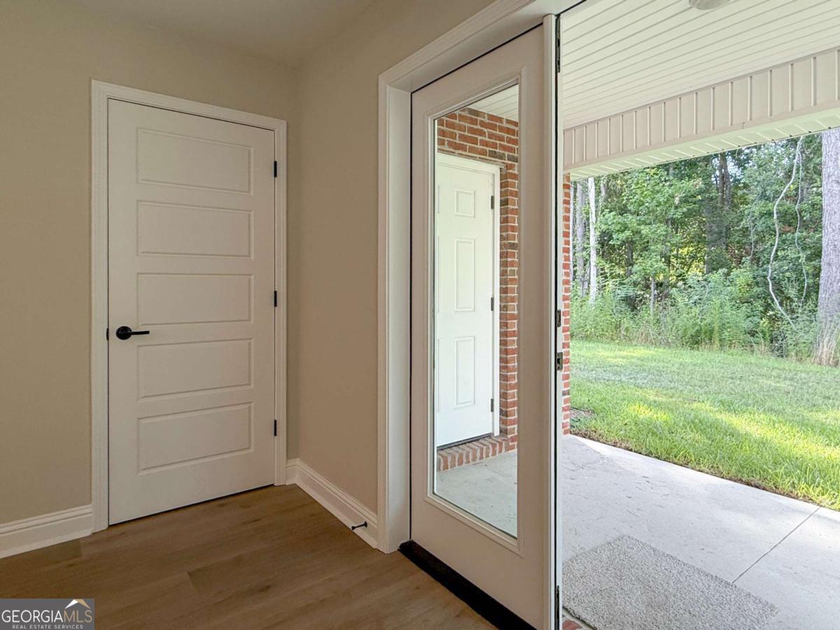 411 Madison Avenue St. Marys, GA 31558 - Photo 10 of 41 an empty room with wooden floor and windows