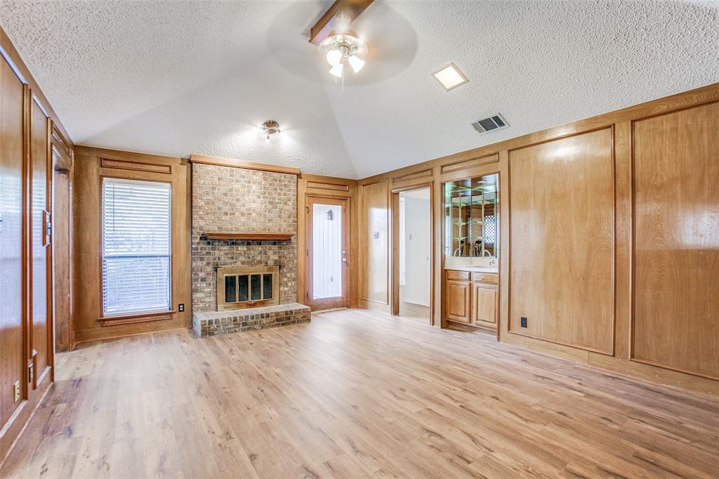 2448 Ridgestone Drive Dallas, TX 75287 - Photo 1 of 1 wooden floor fireplace and windows in an empty room