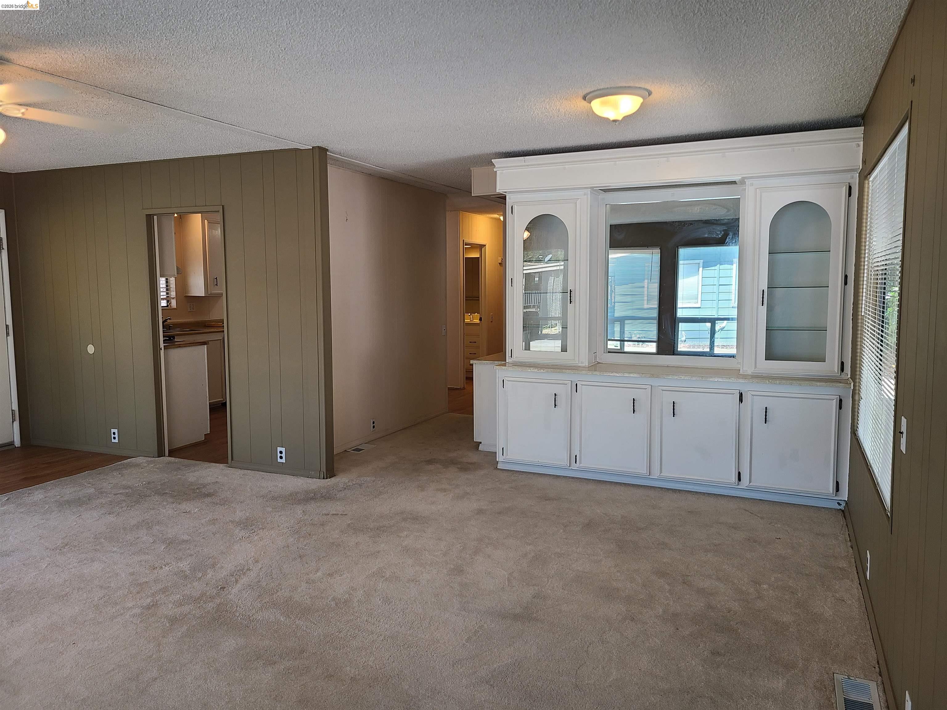 50 Leo Lane, Unit 50 Antioch, CA 94509 - Photo 12 of 64 an empty room with mirror and windows