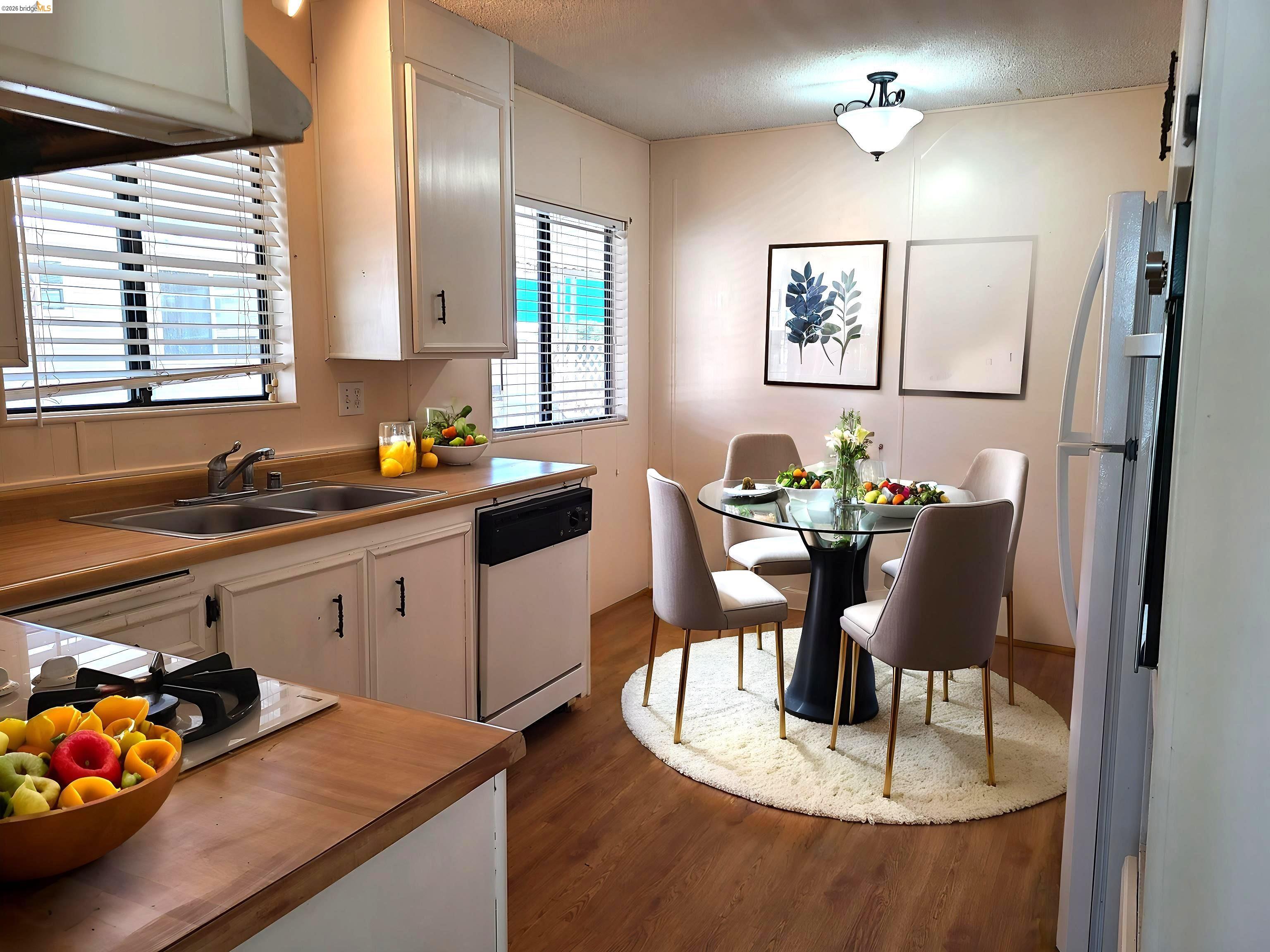 50 Leo Lane, Unit 50 Antioch, CA 94509 - Photo 15 of 64 a kitchen with a dining table chairs and white appliances