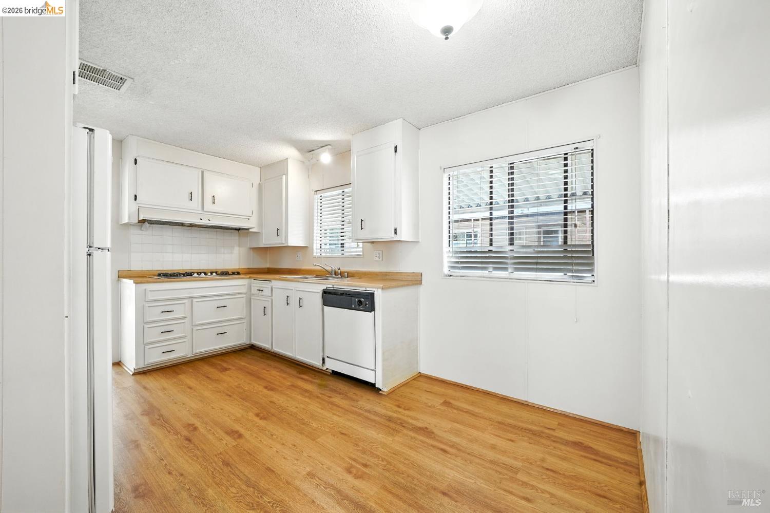 50 Leo Lane, Unit 50 Antioch, CA 94509 - Photo 18 of 64 a kitchen with granite countertop white cabinets and white appliances