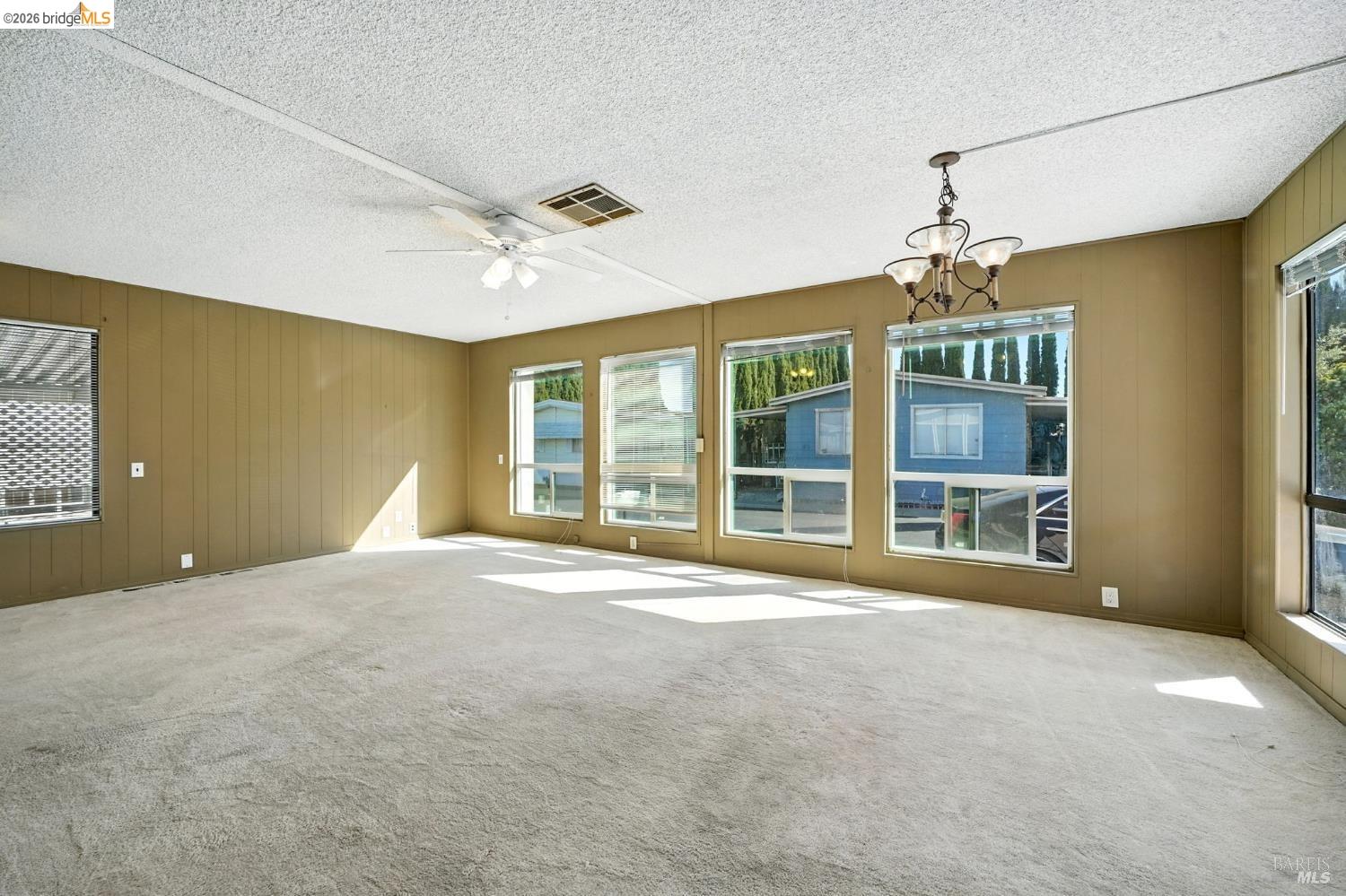 50 Leo Lane, Unit 50 Antioch, CA 94509 - Photo 10 of 64 a view of an empty room with a window and chandelier fan