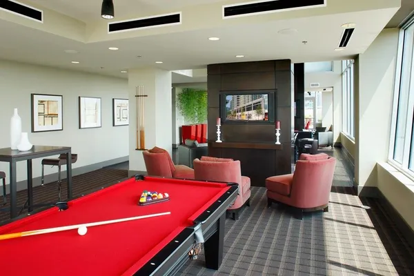 a living room with furniture wooden floor and a large window