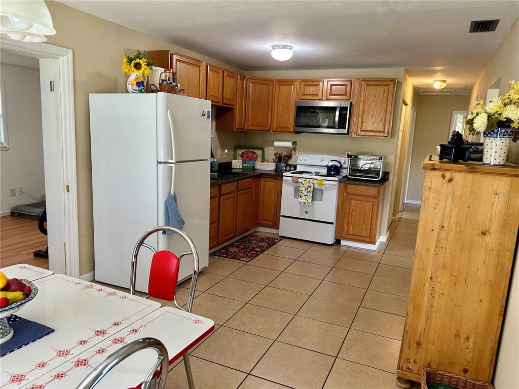 304 Bell Street Wauchula, FL 33873 - Photo 14 of 41 a kitchen with stainless steel appliances granite countertop a refrigerator stove top oven a sink and dishwasher