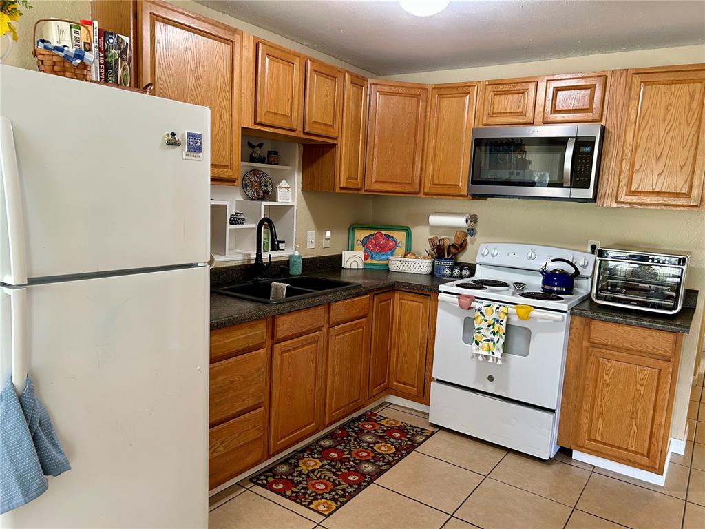 304 Bell Street Wauchula, FL 33873 - Photo 18 of 41 a kitchen with stainless steel appliances granite countertop a refrigerator sink and microwave