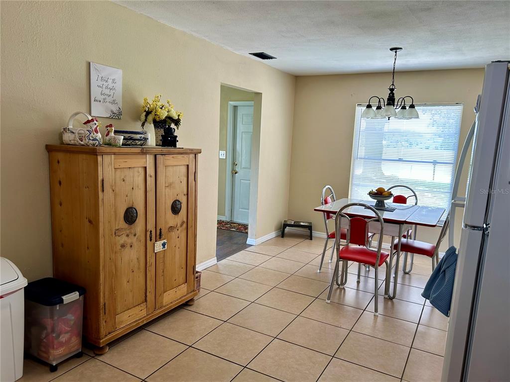 304 Bell Street Wauchula, FL 33873 - Photo 20 of 41 a view of a dining room with furniture and a chandelier