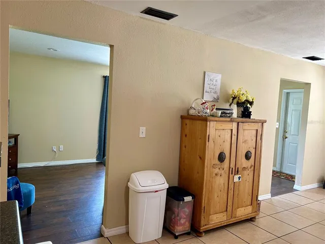 a view of a hallway with wooden floor and closet