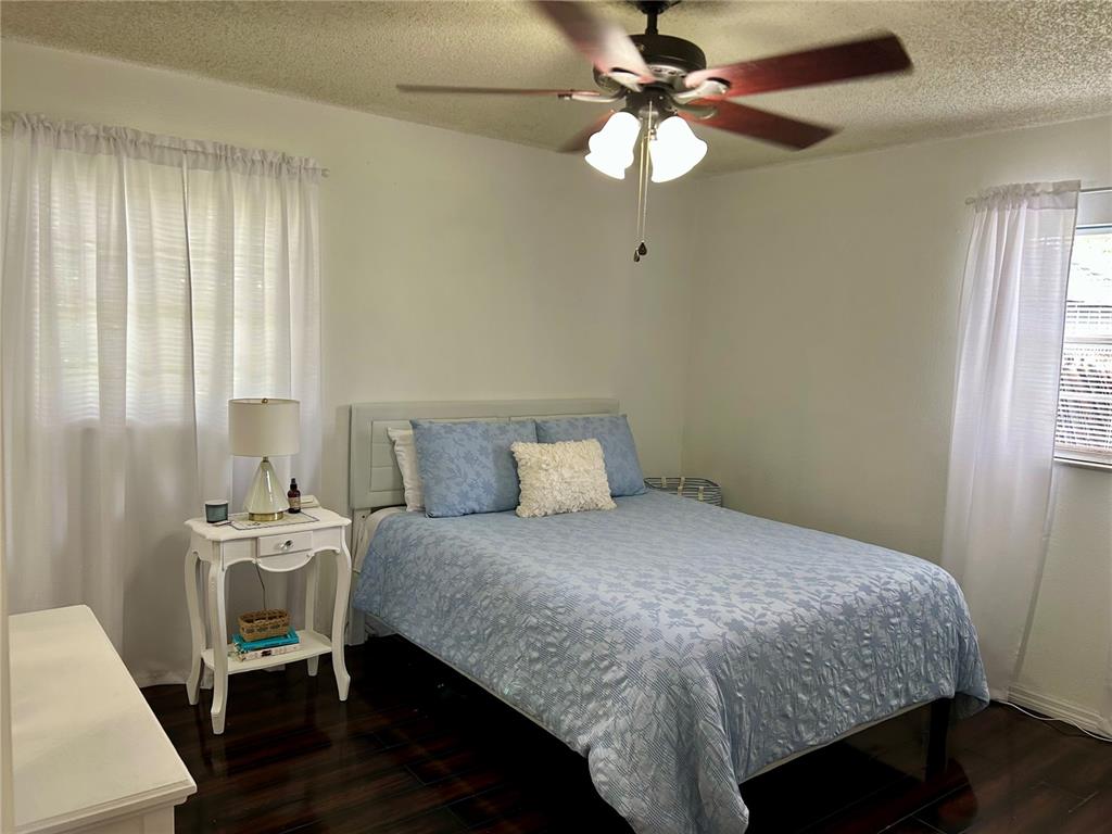 304 Bell Street Wauchula, FL 33873 - Photo 27 of 41 a bedroom with a bed and a chandelier