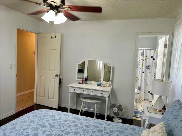 a bedroom with a bed and flat screen tv
