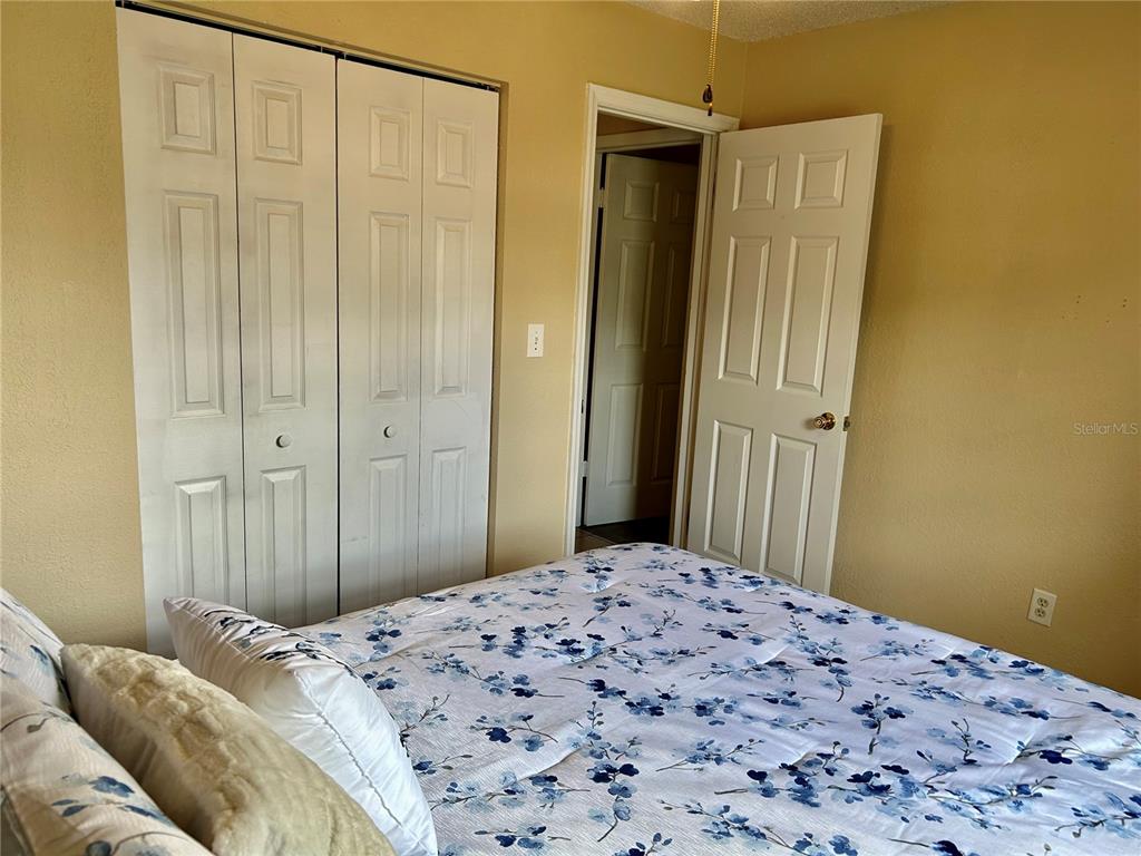 304 Bell Street Wauchula, FL 33873 - Photo 34 of 41 a bedroom with a bed and a chandelier