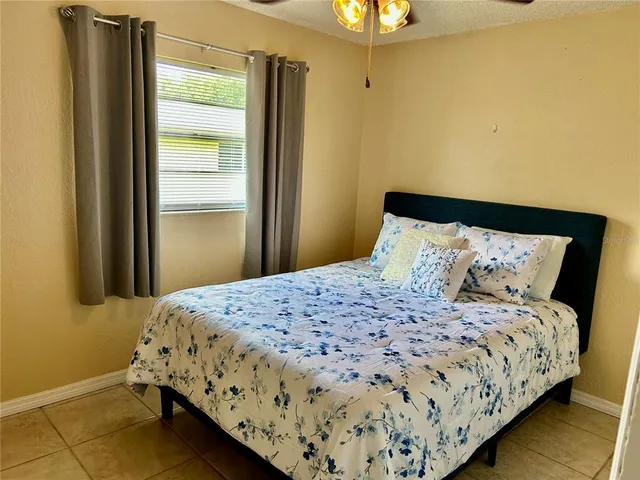 a bedroom with a bed and a rug