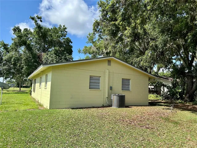 a view of backyard of house with green space